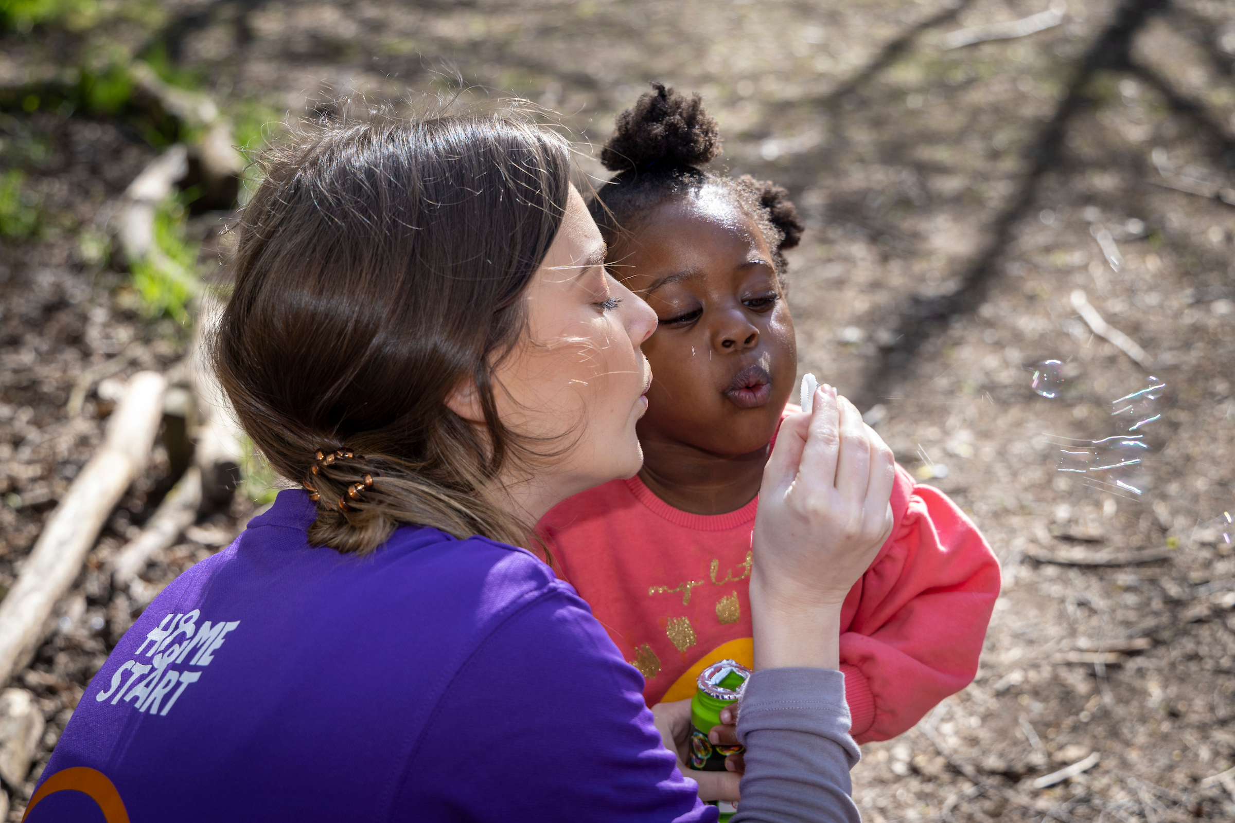 Child enjoying some colouring with a Home-Start volunteer